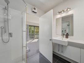 A bathroom with a shower and sink at Lyttelton Holiday Home in Lyttelton