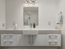 A bathroom with a sink and mirror at Lyttelton Holiday Home in Lyttelton