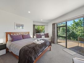 A bedroom with a bed and couch at Lyttelton Holiday Home in Lyttelton