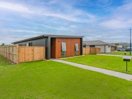A house with a pathway and fence at Sun and Sea Sanctuary - Whitianga