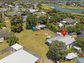 An aerial view of residential houses and gardens at Whitianga Holiday Home in Whitianga