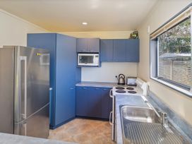 A kitchen with appliances at Whitianga Holiday Home in Whitianga