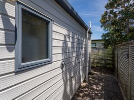An outdoor area with a window and fence at Whitianga Holiday Home in Whitianga