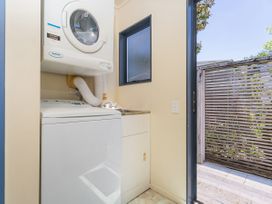 A laundry room with a washing machine and dryer at Whitianga Holiday Home in Whitianga