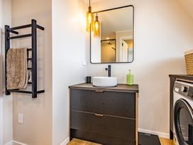 A bathroom with a sink and washing machine at Ohakune Holiday Home Ohakune