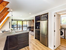 A kitchen with a dining table and a sofa at Ohakune Holiday Home in Ohakune