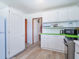 A kitchen with countertop and appliances at Ocean Whispers - Whitianga