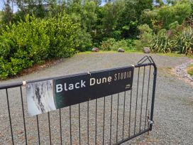 A sign for Black Dune Studio at the entrance with greenery in Waipu