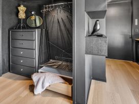 A closet with a dresser and mannequin at Black Dune in Waipu