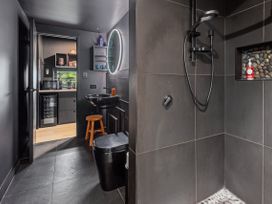 A bathroom with a shower and toilet at Black Dune in Waipu