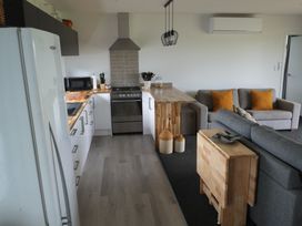 A kitchen with a seating area at Moeraki Holiday Home in Moeraki
