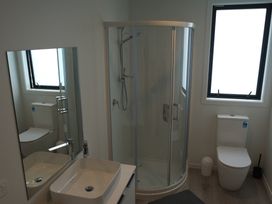 A bathroom with a shower and a toilet at Moeraki Holiday Home Moeraki