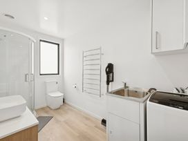 A bathroom with a shower and sink at Seabreeze Lookout - Moeraki