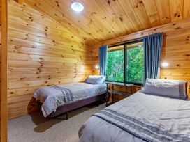 A bedroom with two beds and a window at Lake Taupo Holiday Home in Turangi
