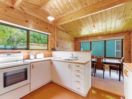A kitchen with a sink and stove at Lake Taupo Holiday Home in Turangi