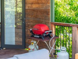 A grill on a table with a propane tank at Lake Taupo Holiday Home in Turangi
