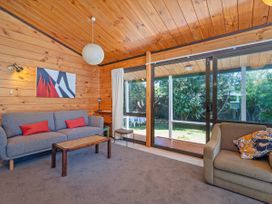 A living room with a sofa and coffee table at Pauanui Sea Esta in Pauanui