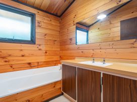 A bathroom with a sink and bathtub at Pauanui Sea Esta in Pauanui
