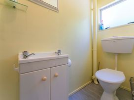 A bathroom with a sink and toilet at Lake Taupo Holiday Home in Turangi