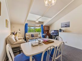 A living room with a television and sofa at Lake Taupo Holiday Home in Turangi
