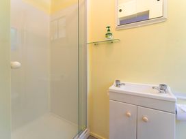A bathroom with a shower and sink at Lake Taupo Holiday Home in Turangi