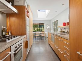 A kitchen with a stove and a table at Brook Beauty - Nelson Holiday Home in Nelson