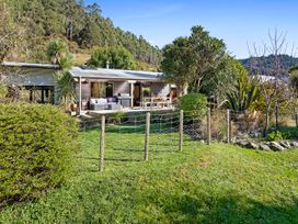 A house with a fence and garden area at Brook Beauty - Nelson Holiday Home, Nelson