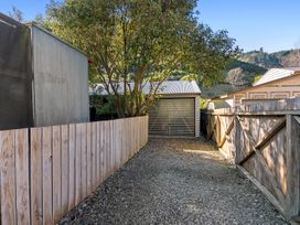 An outdoor area with a gravel path and a shed at Brook Beauty - Nelson Holiday Home in Nelson
