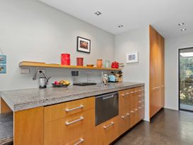 A kitchen with a countertop and dishware at Brook Beauty - Nelson Holiday Home in Nelson