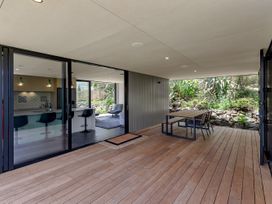 An outdoor area with a table and chairs at Tutukaka in Whangarei