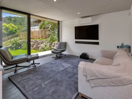 A living room with a sofa and chairs at Tutukaka in Whangarei