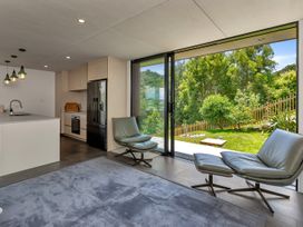 A kitchen area with island and seating at Tutukaka in Whangarei