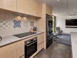 A kitchen with appliances and furniture at Tutukaka in Whangarei