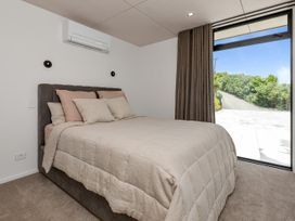 A bedroom with a bed and window at Tutukaka in Whangarei