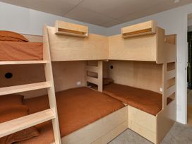 A bedroom with bunk beds and mattresses at Tutukaka in Whangarei