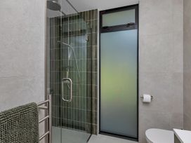 A bathroom featuring a shower and toilet at Tutukaka in Whangarei