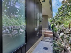 An outdoor shower next to a wooden platform at Tutukaka in Whangarei