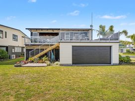 A house with a deck and garage in Whitianga