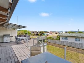 An outdoor area with a table and chairs at Whitianga, Whitianga