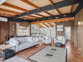 A living room with a sofa and coffee table at Whitianga