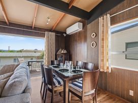 A dining room with a table and chairs at Whitianga