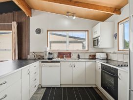 A kitchen with sink and appliances at Whitianga