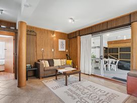 A living room with a sofa and coffee table at Whitianga