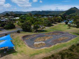An outdoor skate park with a road and trees near Tides and Time Bach - Ahipara Holiday Home Kaitaia
