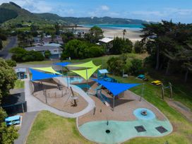 A playground with sail shades and equipment at Tides and Time Bach - Ahipara Holiday Home Kaitaia
