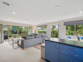 A living room with a sofa and table at Martinborough Holiday Home in Martinborough