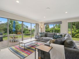 A living room with a sofa and coffee table at Martinborough Holiday Home Martinborough