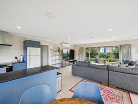 A living room with a sofa and television at Martinborough Holiday Home in Martinborough