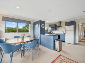 A kitchen with a dining table and chairs at Martinborough Holiday Home, Martinborough
