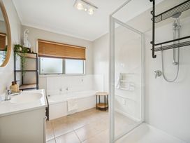 A bathroom with a bathtub and shower at Martinborough Holiday Home in Martinborough